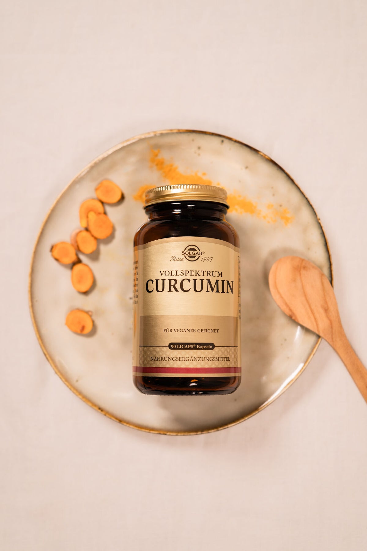Solgar Curcumin Produkt neben Kurkuma Stücken und Pulver